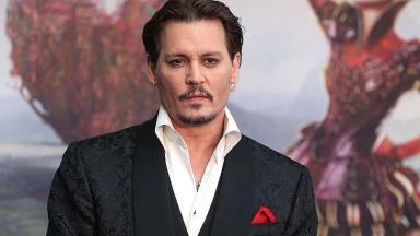 Johnny Depp de terno e lenço vermelho  