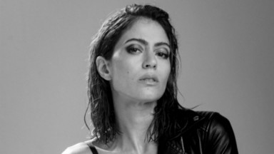  Carol Castro em foto em preto e branco, de cabelos soltos e molhados, sem sorrir 
