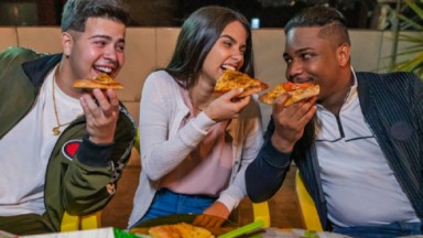 Protagonistas de Sintonia, da Netflix comendo pizza 