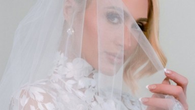 Paris Hilton vestida de noiva olhando para a câmera e posando para foto 