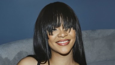 Rihanna sorrindo com franja 