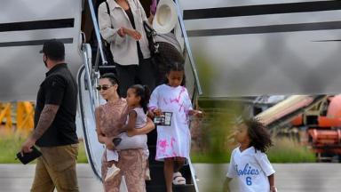 Kim Kardashian, Kanye West e os filhos desembarcando 