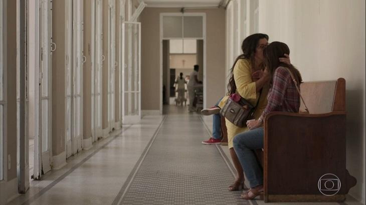 Lurdes (Regina Casé) dá um beijo na testa de Thelma (Adriana Esteves) no corredor de um hospital em Amor de Mãe