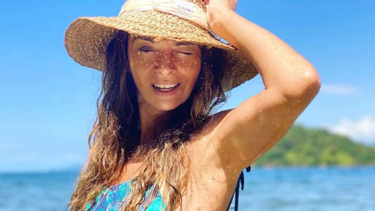 Claudia Ohana posada com chapéu na praia
