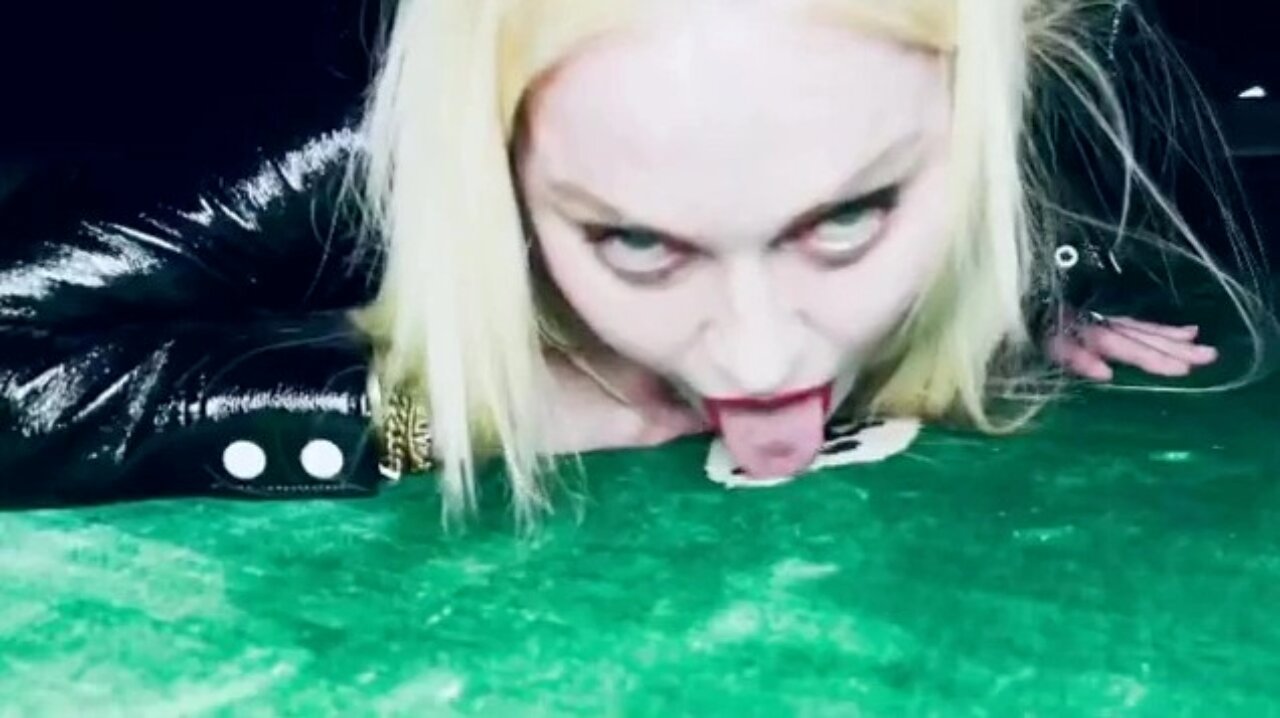 Madonna lambendo o chão, olhando para a câmera